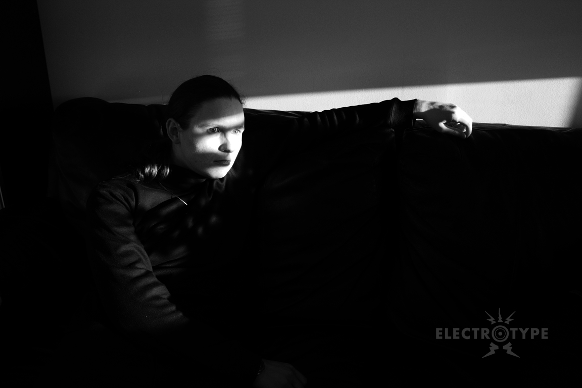 Beth in black sitting on couch